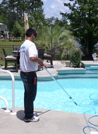 Pool Medic performing pool cleaning services